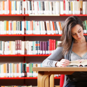 Portrait of a student  girl studying at library